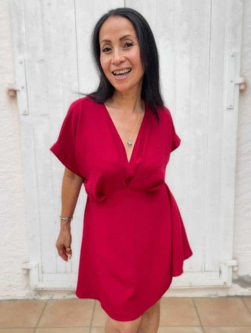 Mel H Lopez in a red dress, founder of Insatiable Mel rapid recovery from binge eating